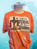 Heather Orange bleach patterned tee with a cross and pumpkins and the saying Fall for Jesus He Never Leaves.