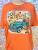Heather Orange Bleached tee with Happy Fall Y'all quote and images of old truck and pumpkins.