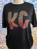 Black tshirt with initial KC in half leopard print and half maroon color on bottom.