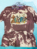Heather Maroon bleach patterned tee with the word Teacher spelled with a cross for the T surrounded by Christian themed items.