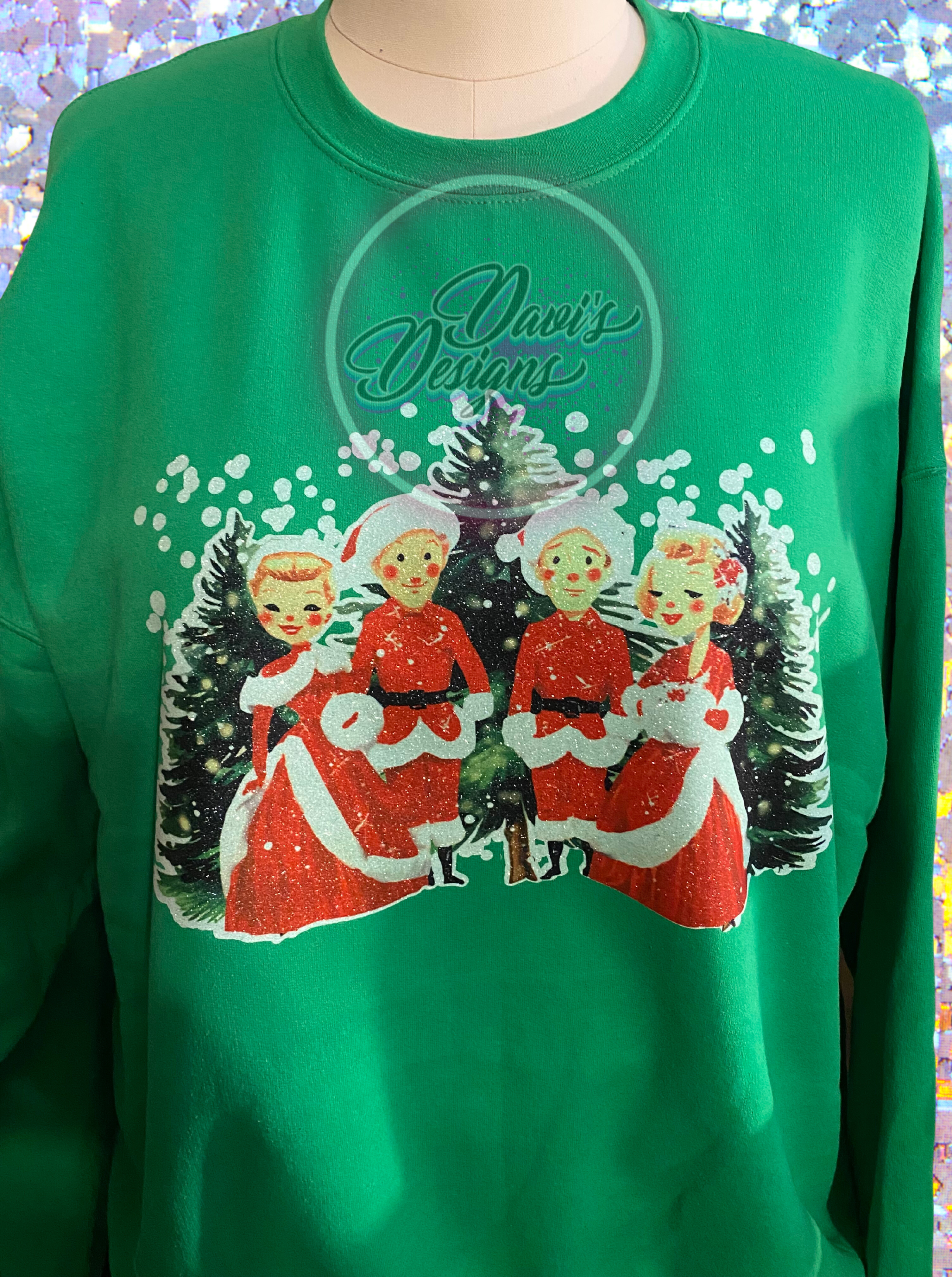 White Christmas scene sublimated on white glitter vinyl on an Irish Green sweetshirt.